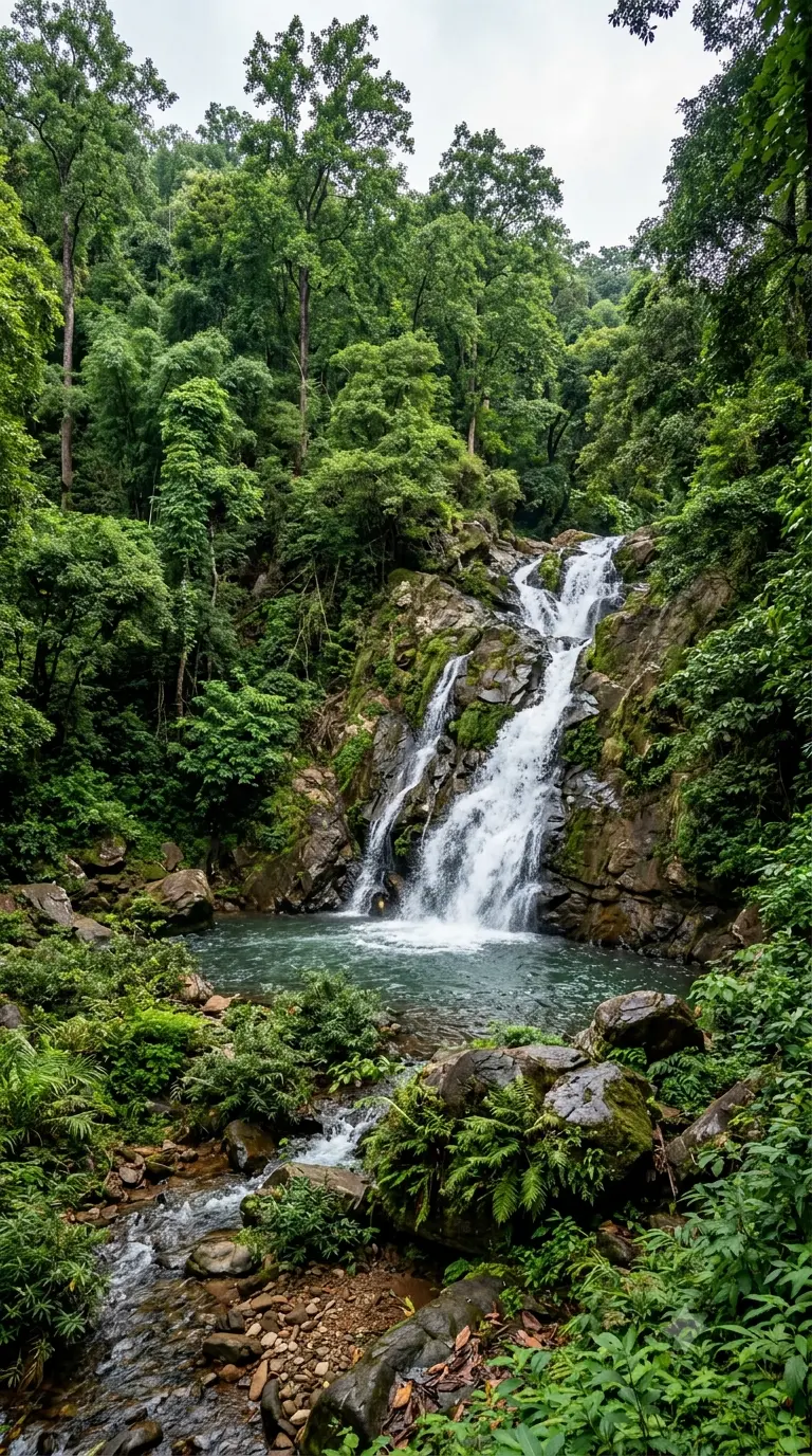 Barehipani Waterfall cascading into the emerald gorge pool